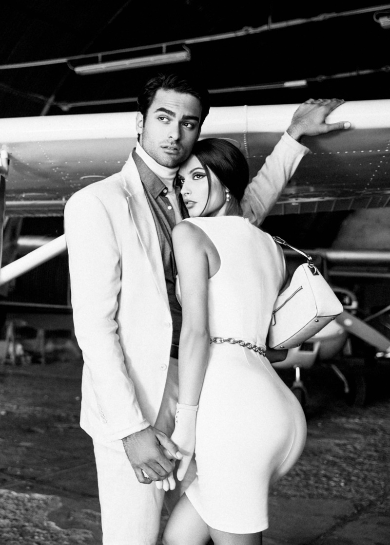 Jet-set glamour takes flight with chic white outfits featured in Guess' holiday 2023 advertisements.