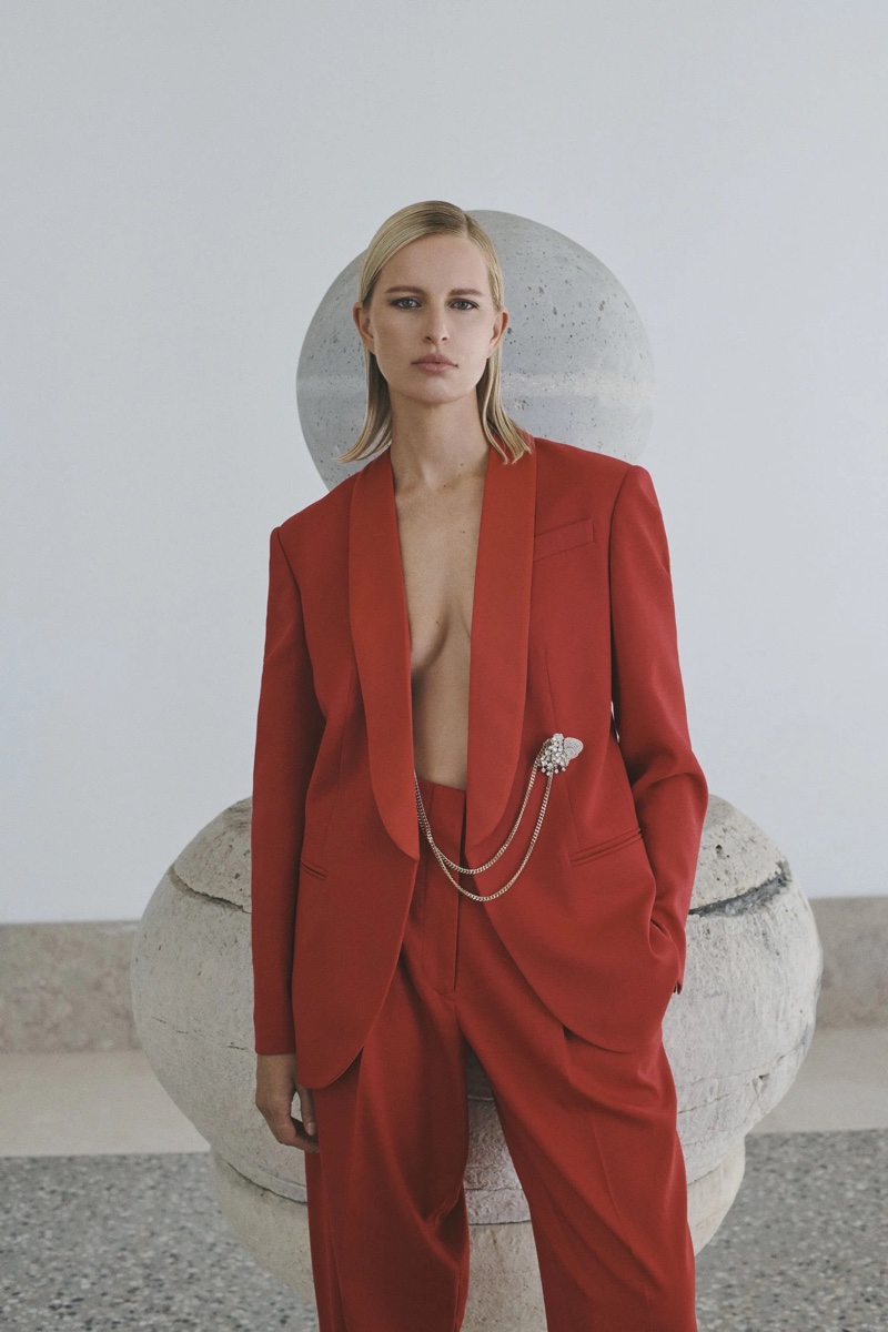 Karolina Kurkova makes a bold statement in a chic red pantsuit with jewelry accents in the Genny winter 2023 campaign.