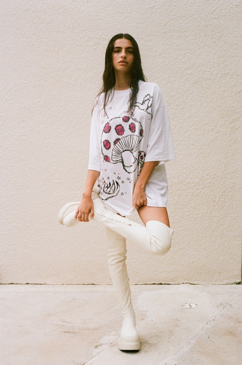 SSENSE x Marni capsule showcasing a graphic oversized tee with mushroom motifs, complemented by sleek white platforms.