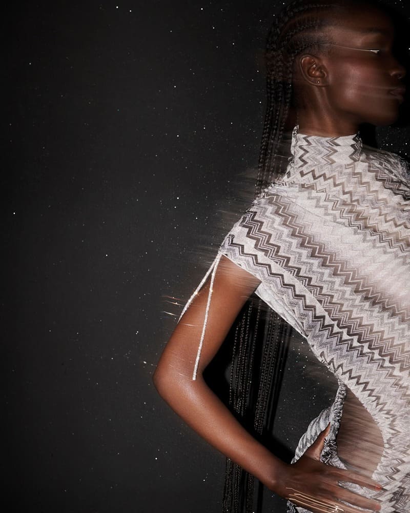 Captured mid-motion, Maty Fall showcases Missoni's signature zigzag dress for its fall-winter 2023 campaign.
