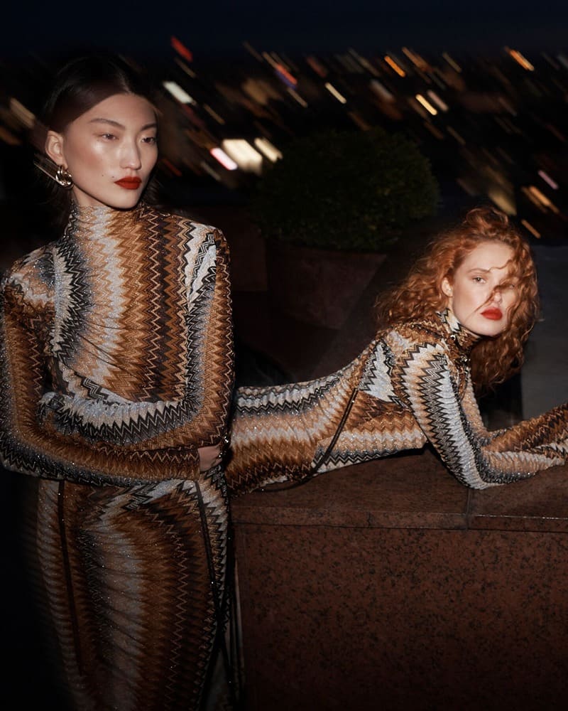 Yang Ling and Liv Walters embrace knit dresses for the Missoni winter 2023 campaign, captured under the city's twinkling lights.