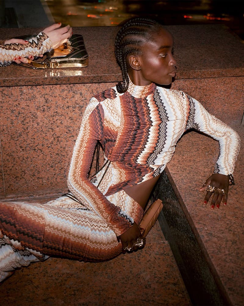 Maty Fall shows off a body-hugging knit ensemble while posing in the Missoni fall-winter 2023 campaign, complemented by golden accessories.