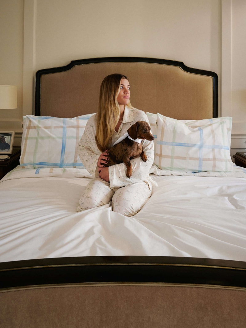 Sofia Richie wraps up in Djerf Avenue's winter cozy pajama set, alongside a furry friend.