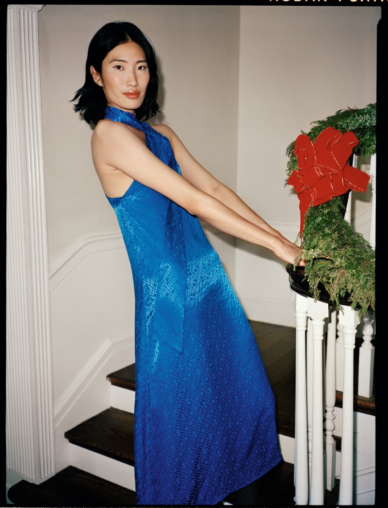 Nuri Son strikes a pose in a dazzling blue halter-neck gown for the Tommy Hilfiger holiday 2023 campaign.