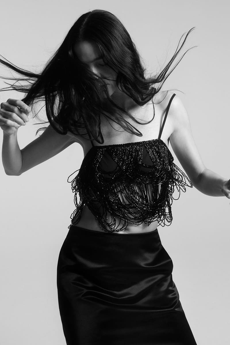 Mariacarla Boscono strikes a pose in beaded crop top with satin-effect skirt for Zara's winter party edit.