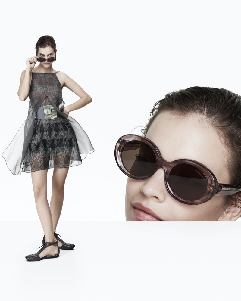 Sporting oversized sunglasses, Barbara Palvin epitomizes chic in a translucent Emporio Armani dress for spring 2024.