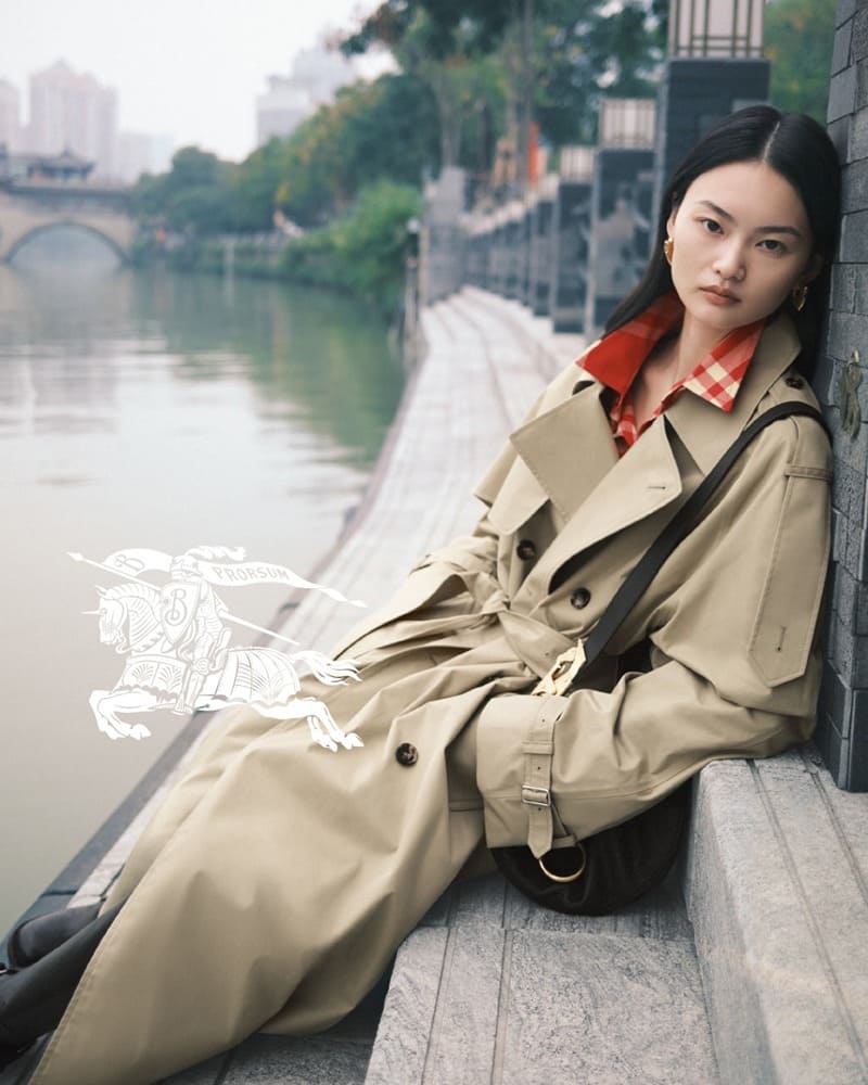 Model He Cong fronts Burberry's Lunar New Year 2024 campaign in a timeless trench with a riverside reverie.
