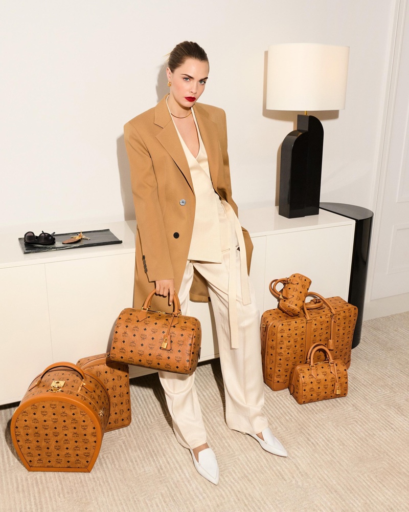 Structured elegance: Cara Delevingne in a tan blazer and white suit with MCM's spring 2024 accessories.