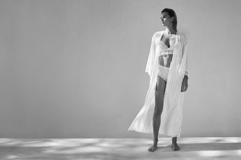 Draped in a sheer robe, Edita Vilkeviciute poses in Eres's spring 2024 campaign.