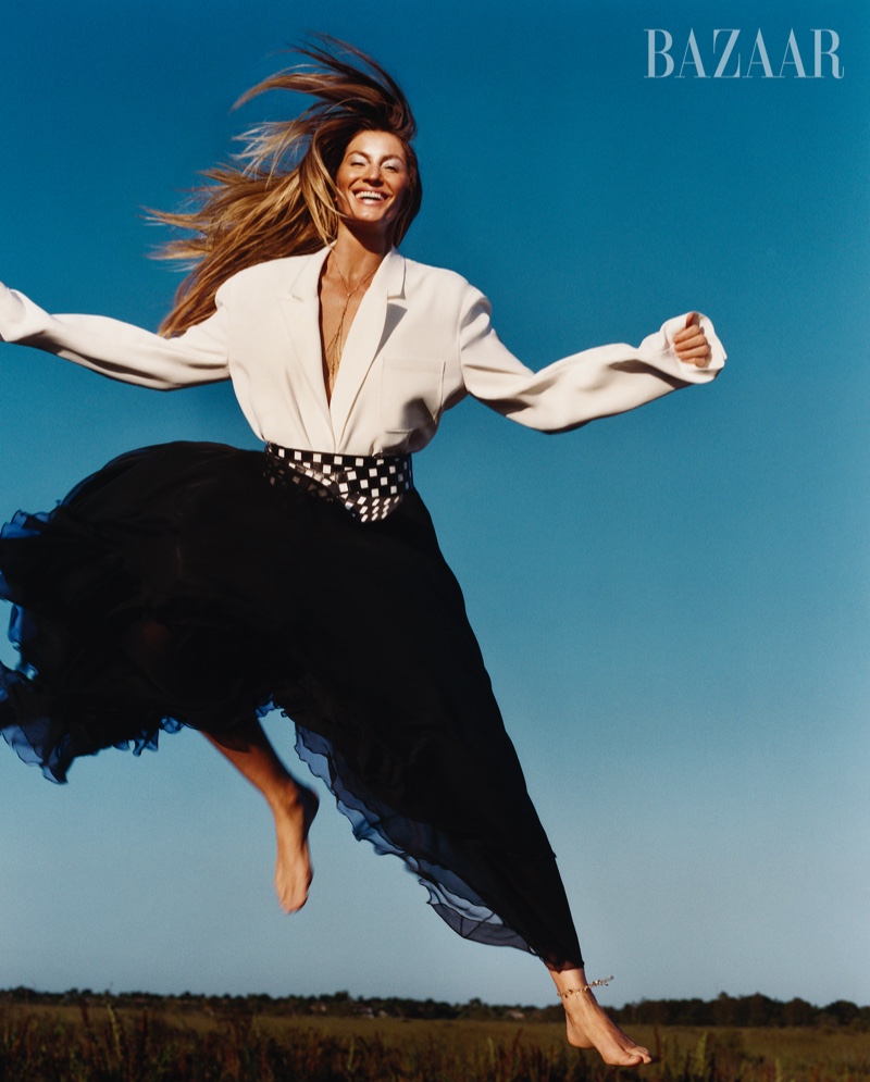 Jumping for joy, Gisele Bundchebn models Louis Vuitton outfit with a breezy silhouette.