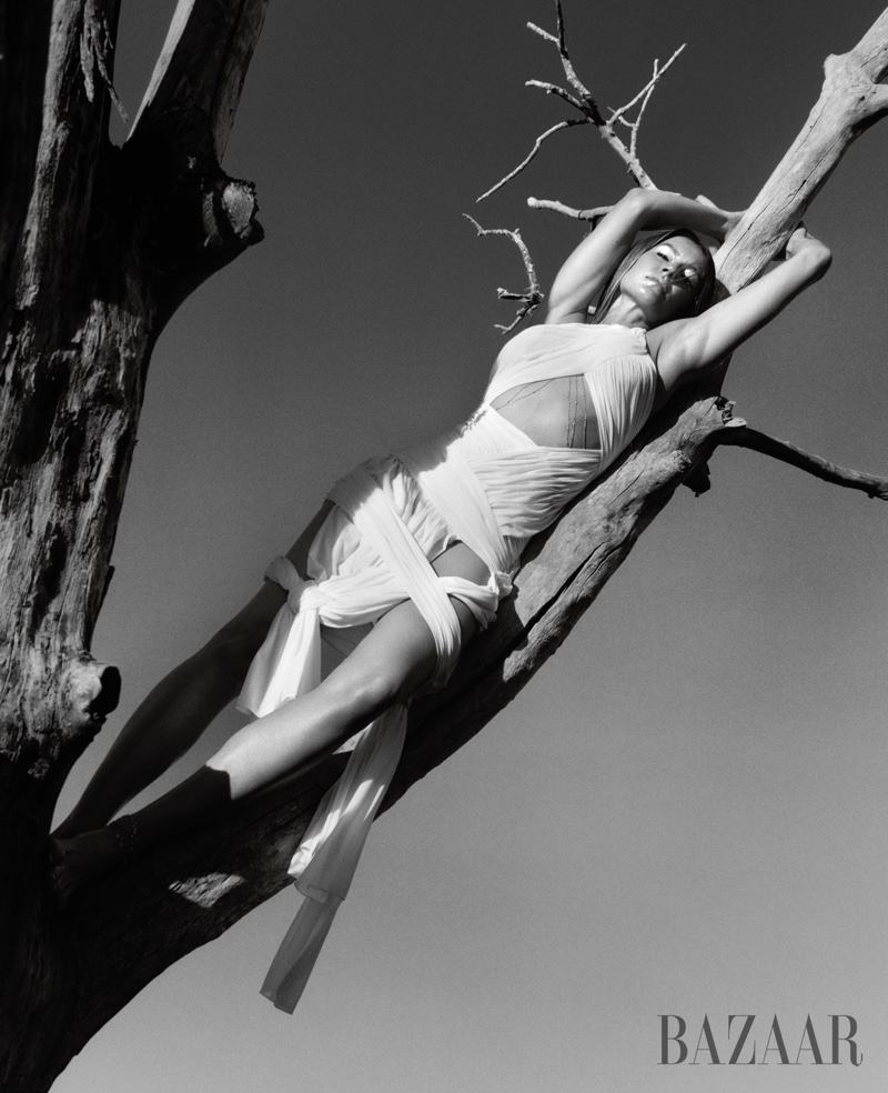 Lounging in a tree, Gisele Bundchen shows off a JW Anderson wrap dress.