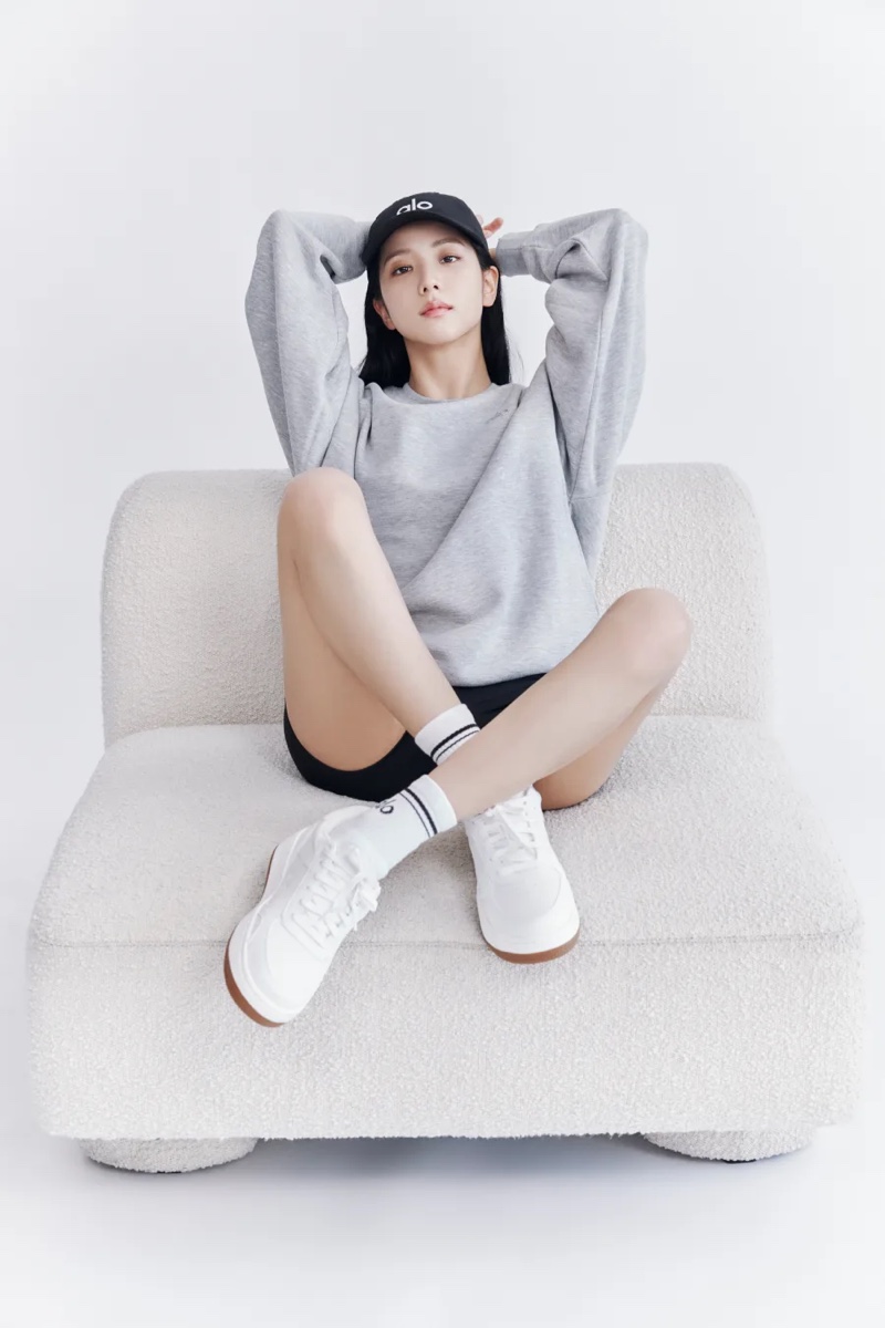 Keeping relaxed, Jisoo wears Alo Yoga's spring 2024 baseball cap, sweatshirt, and shorts.