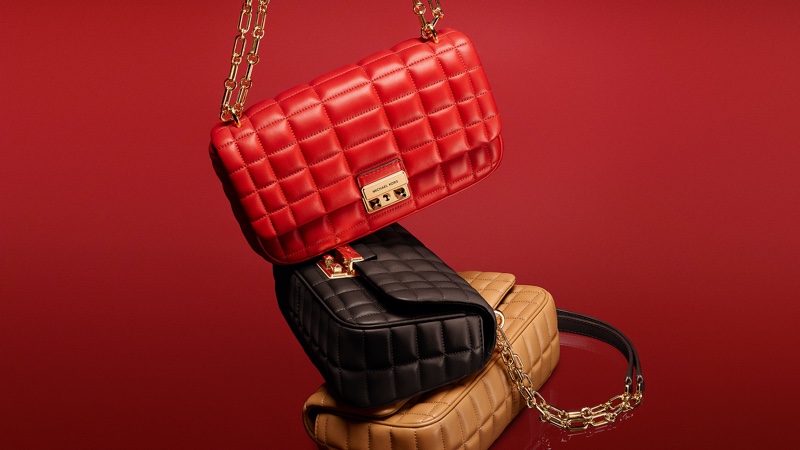 Luxurious and stacked: Michael Kors Tribeca bags in red, black, and camel for 2024.