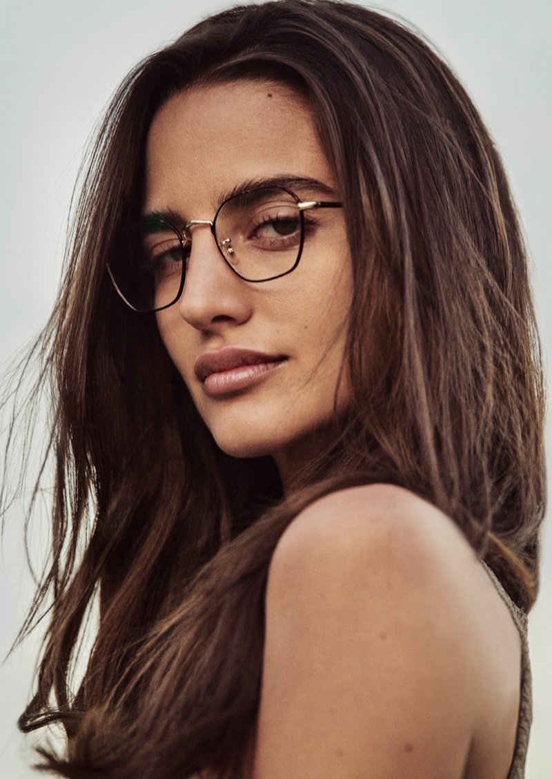 A spring 2024 advertisement for Oliver Peoples channels scholarly style with metal frame glasses.