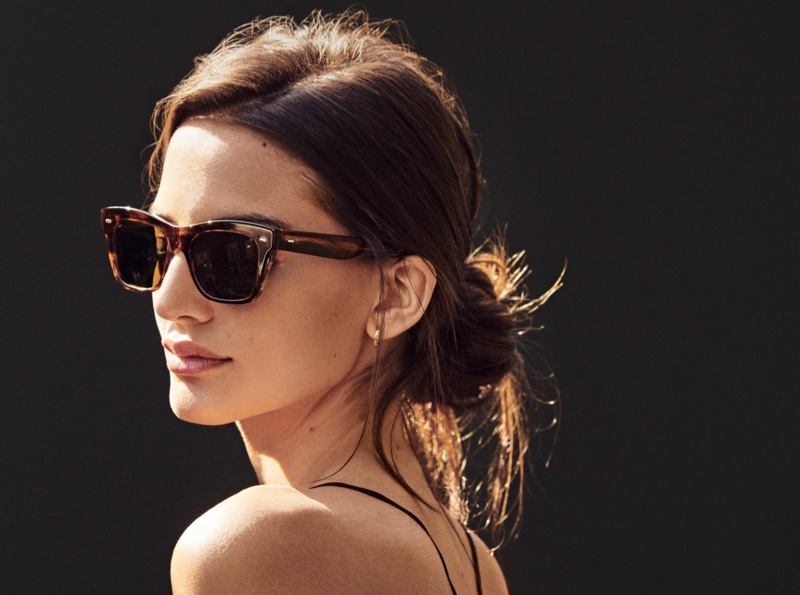 In Oliver Peoples' spring 2024 campaign, Mili Pineiro models tortoiseshell sunglasses that offer timeless elegance.