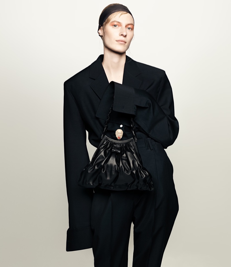 Julia Nobis fronts Prada's spring 2024 campaign, pairing sharp tailoring with soft, gathered designs.