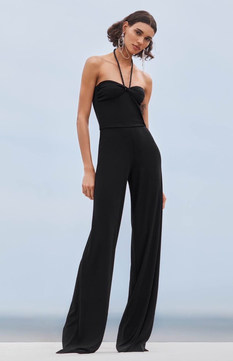Barbara Valente strikes a pose in a black jumpsuit with halter neck straps for the Ralph Lauren resort 2024 collection.