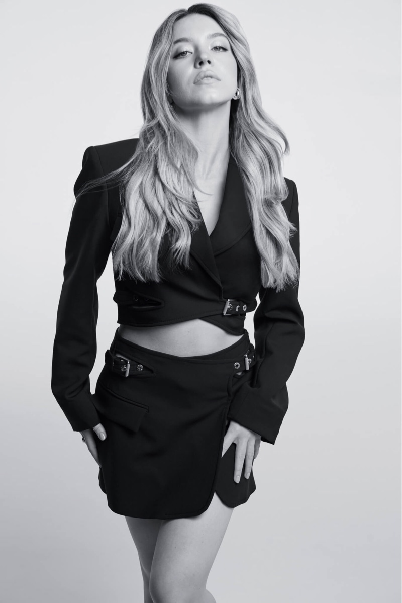 Sydney Sweeney stands poised in Kérastase's photoshoot, wearing an all-black ensemble.