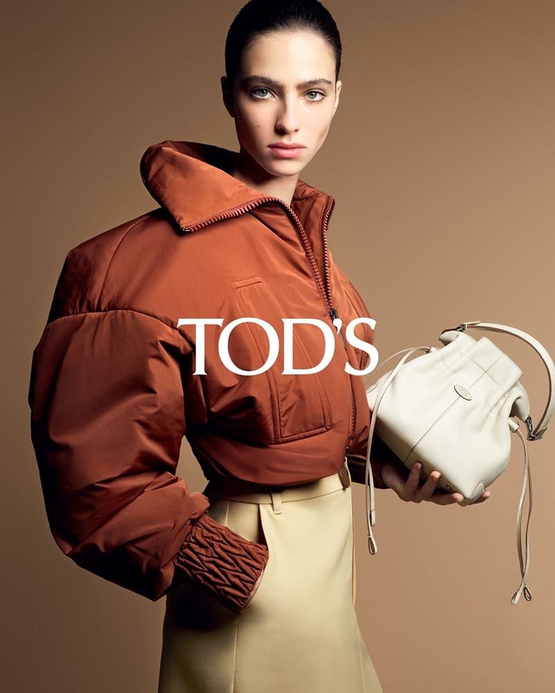 Capturing pre-spring 2024's mood with Tod's: a russet puffer and a soft white bucket bag.