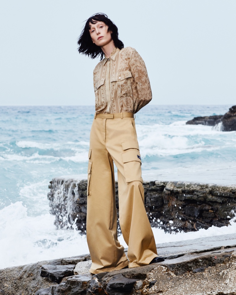 Hunter Pifer models a Barocco silk shirt paired with cargo pants for Versace's resort 2024 campaign.