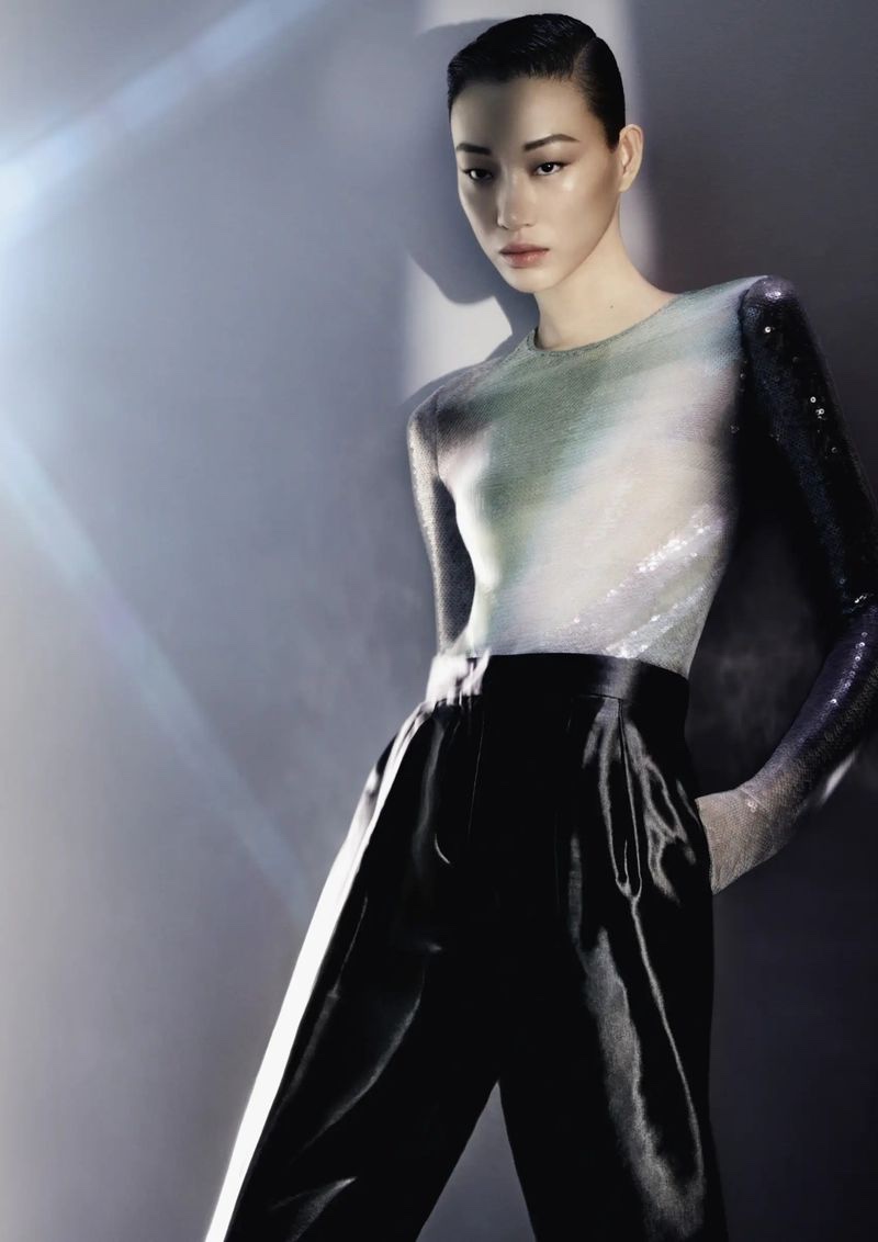 Giorgio Armani unveils spring-summer 2024 ad featuring a sleek, shimmering top with black trousers.