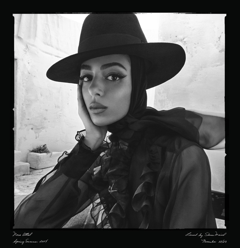 Nora Attal strikes a pose in a fedora hat and ruffled blouse in the Dolce & Gabbana spring 2024 campaign.