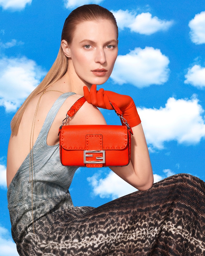Julia Nobis poses with Baguette bag in the Fendi spring-summer 2024 campaign, accessorized with bold red gloves.