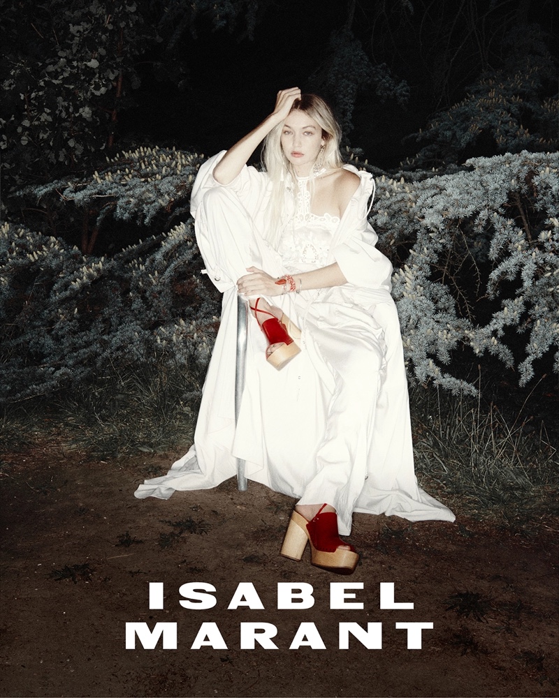 Dressed in a white billowing dress and bold red sandals, Gigi Hadid captivates in Isabel Marant's spring 2024 campaign.