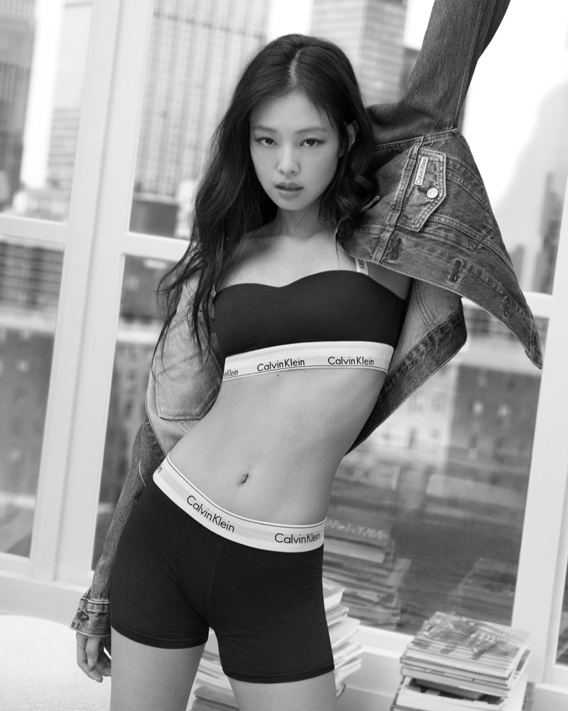 Jennie in a dynamic pose for Calvin Klein's spring 2024 campaign, showcasing branded underwear and a denim jacket.