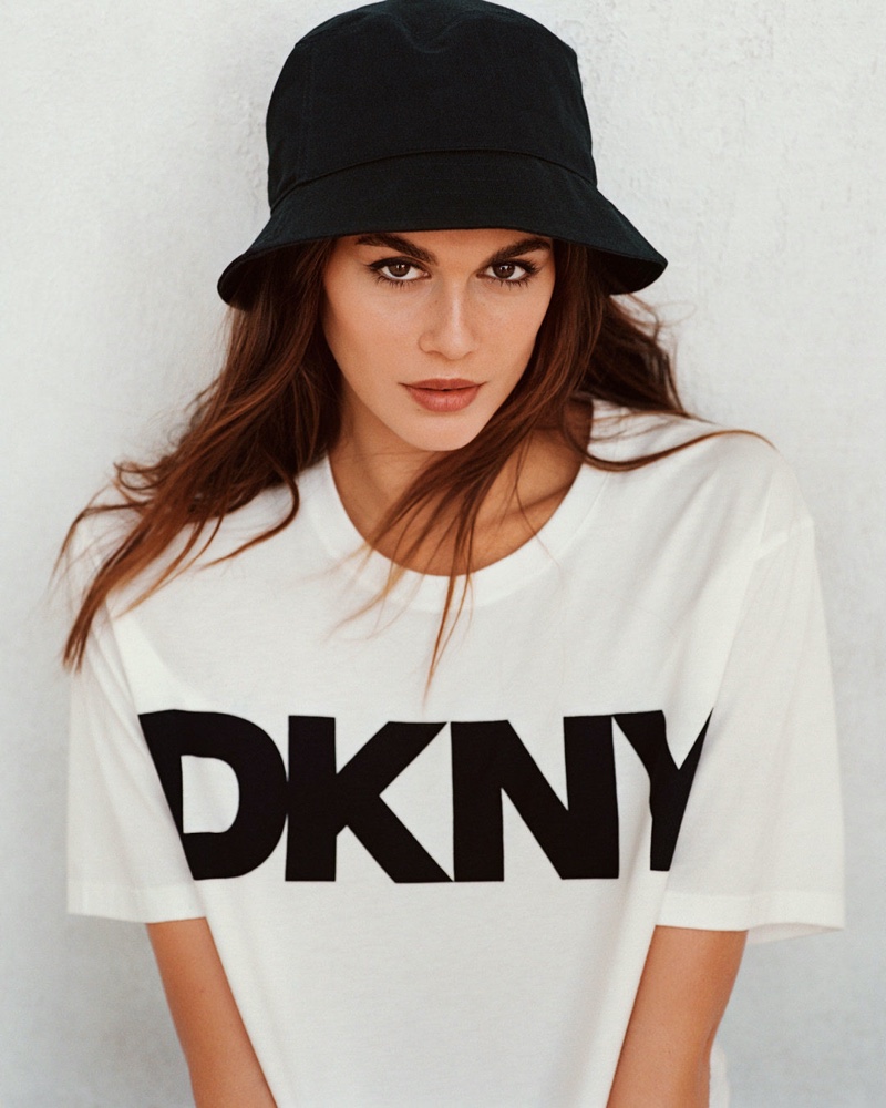 Kaia Gerber rocks a bucket hat and t-shirt in the DKNY spring 2024 ad.