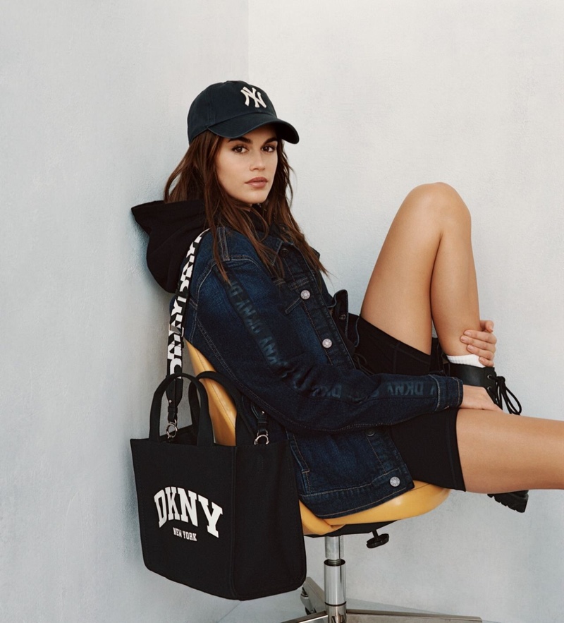 Effortless style: Kaia Gerber showcases DKNY's spring 2024 essentials with a baseball cap and denim.