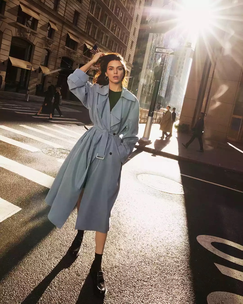 Bathed in sunlight, Kendall Jenner showcases a chic, belted trench coat in the Calvin Klein spring 2024 campaign.