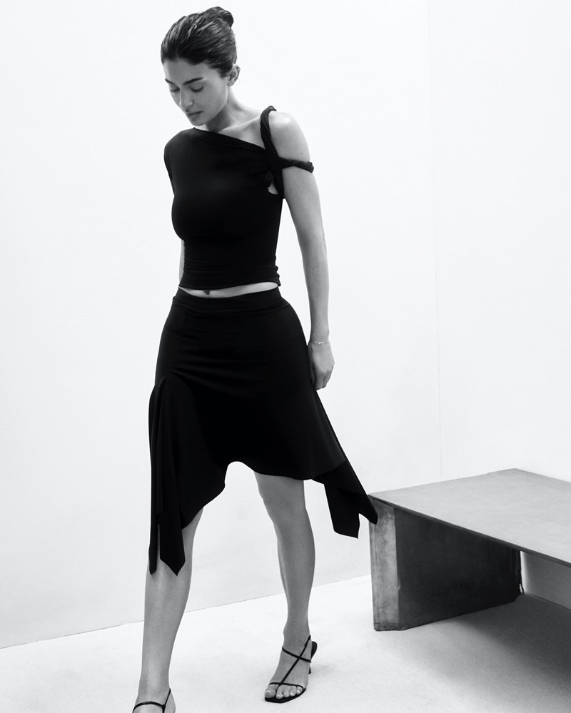 Elegant asymmetry: Kylie Jenner in a black one-shoulder top and skirt for Khy Drop 004.