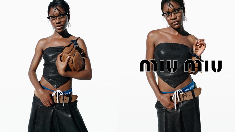 Demi Singleton poses in a tube top and leather skirt for the spring 2024 campaign from Miu Miu.