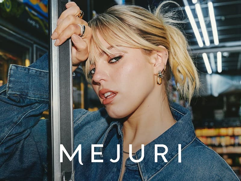 Reneé Rapp pairs denim with Mejuri's golden hoops, blending casual with luxe in the city buzz.