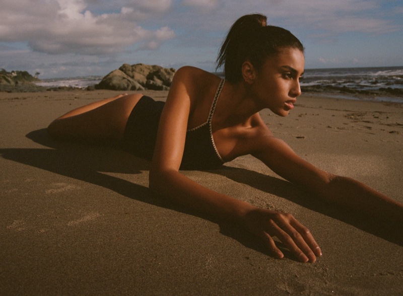 Captured against the beach's backdrop, Imaan lounges gracefully in Zara's asymmetrical swimsuit.