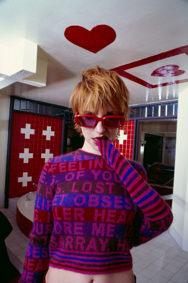 Hayley Williams models a vibrant, text-laden sweater for Heaven by Marc Jacobs' spring 2024 campaign.