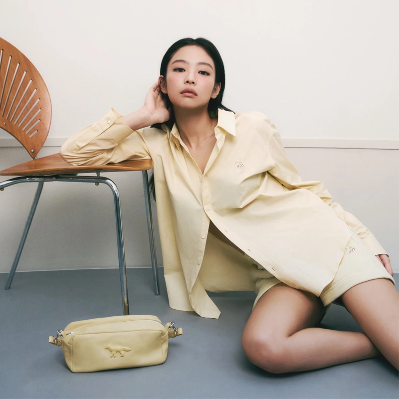 Keeping it casual in yellow, Jennie embraces a button-up shirt and shorts for Maison Kitsuné's Baby Fox spring 2024 collection.