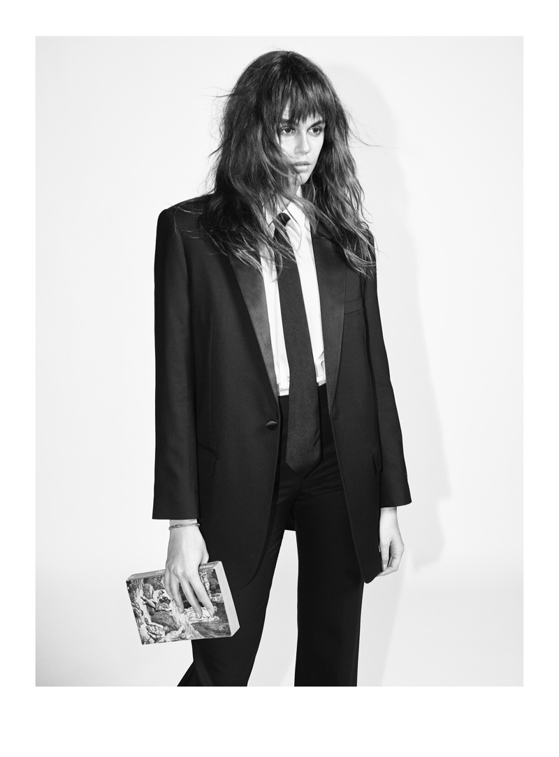 Kaia Gerber poses in Celine pantsuit with tie.