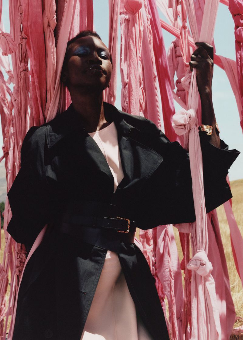 Alek Wek captivates in & Other Stories' spring 2024 campaign, donning a bold black jacket with a cinched waist.