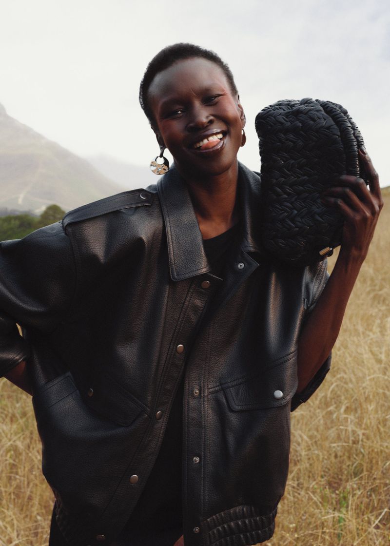 Alek Wek radiates joy for & Other Stories' spring 2024 campaign, her smile as captivating as the sleek leather ensemble she adorns.