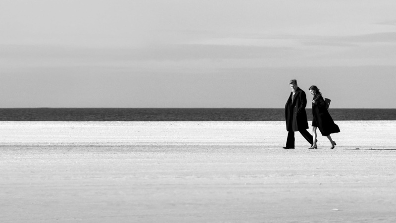 Actors Penélope Cruz and Brad Pitt walk the beach for Chanel's Iconic handbag ad.