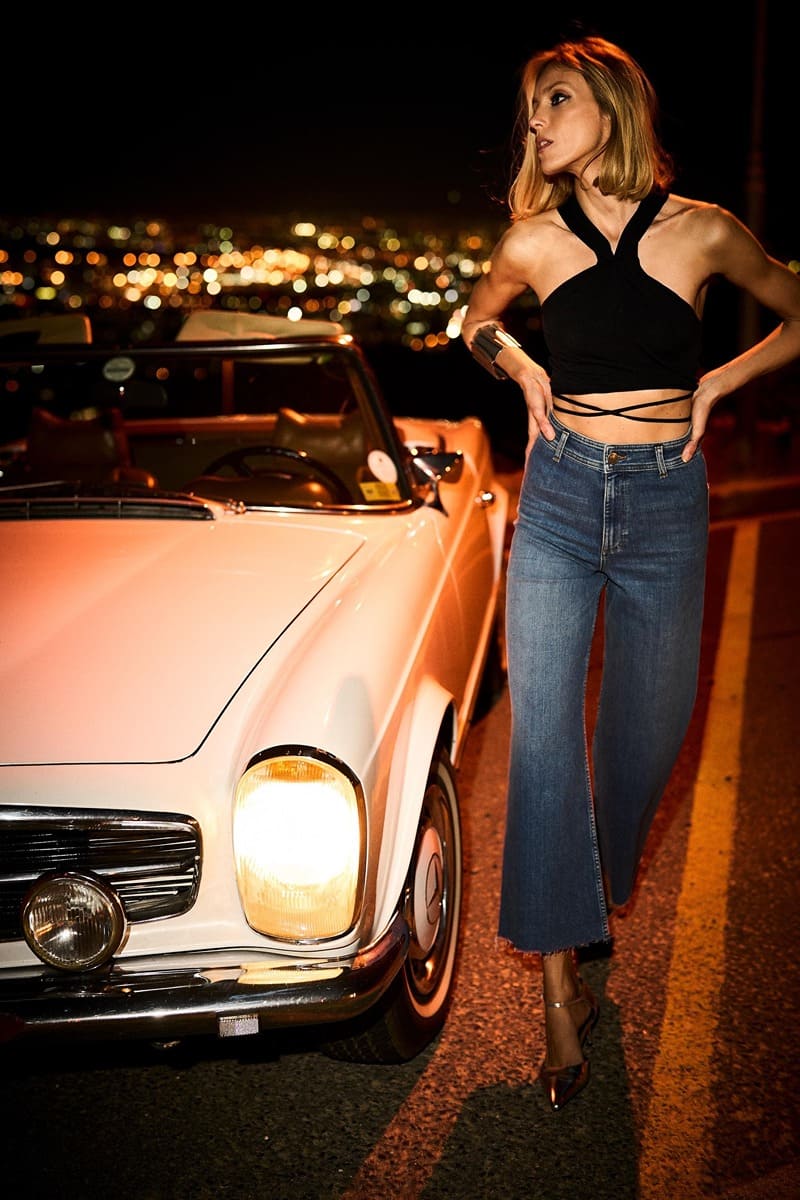 Anja Rubik models a crop top with cropped flared jeans from Zara for spring 2024.