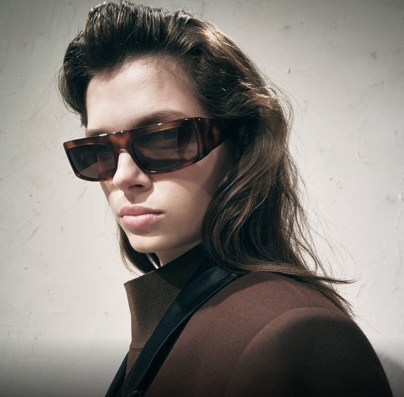 KHAITE x Oliver Peoples spring 2024 campaign captures chic modernity with tortoiseshell frames, adding a vintage flair.