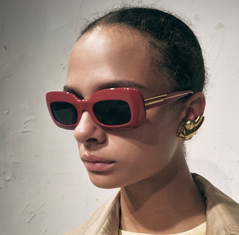 A striking red pair of sunglasses stands out in the KHAITE x Oliver Peoples spring 2024 collection.