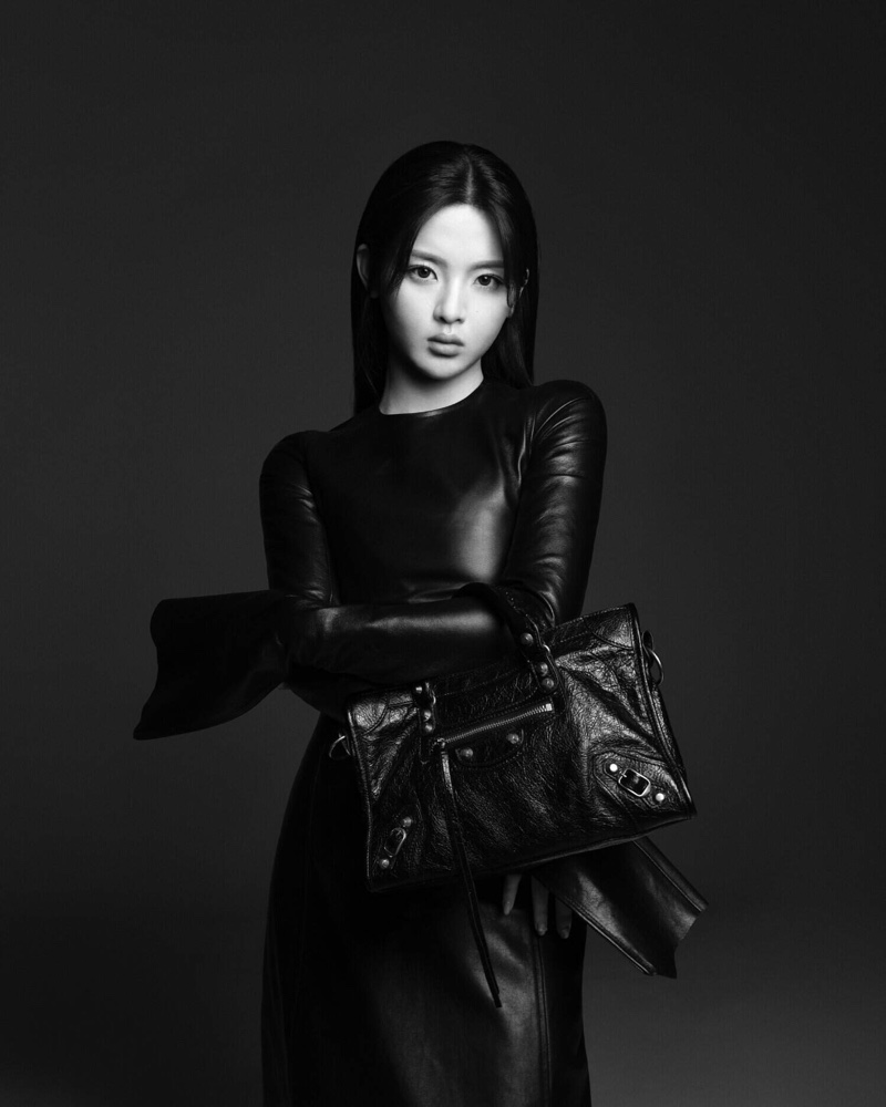 Yang Chaoyue pairs the Balenciaga Le City bag with a leather dress in a new ad.