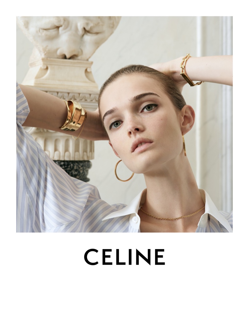 Captured in repose for Des Grands Classiques 08, Lulu Tenney showcases Celine's striped blouse and gold jewelry.