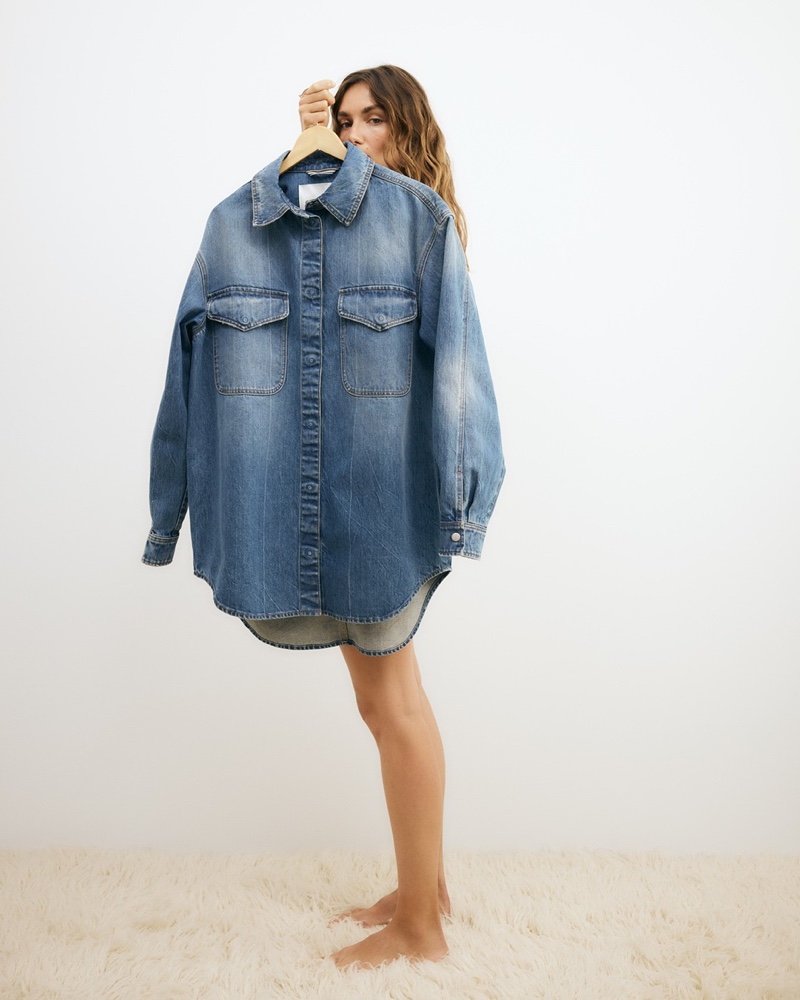 Andreea Diaconu hides behind a jean shirt from Closed's summer 2024 denim series.