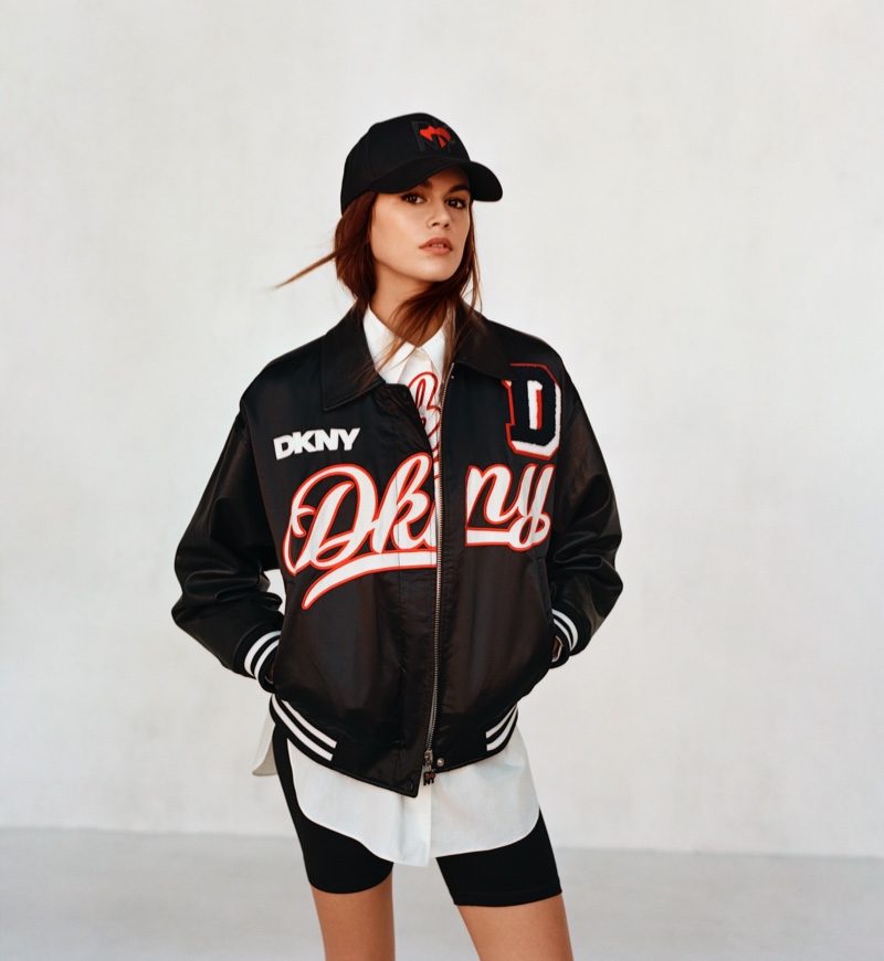 Posing in a bomber jacket, Kaia Gerber gets sporty in a baseball cap for DKNY Heart of NY capsule.