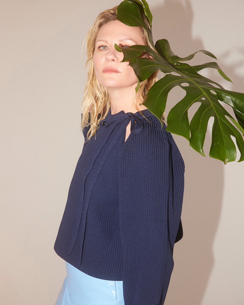 Framed by nature's greenery, Kirsten Dunst gets serene in a navy knit.